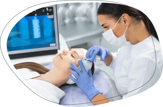 A gloved practitioner treating a woman's face