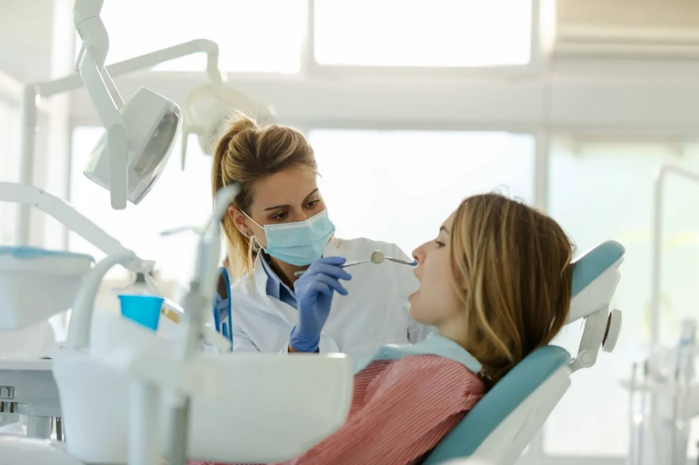 A dentist examining a woman's teeth