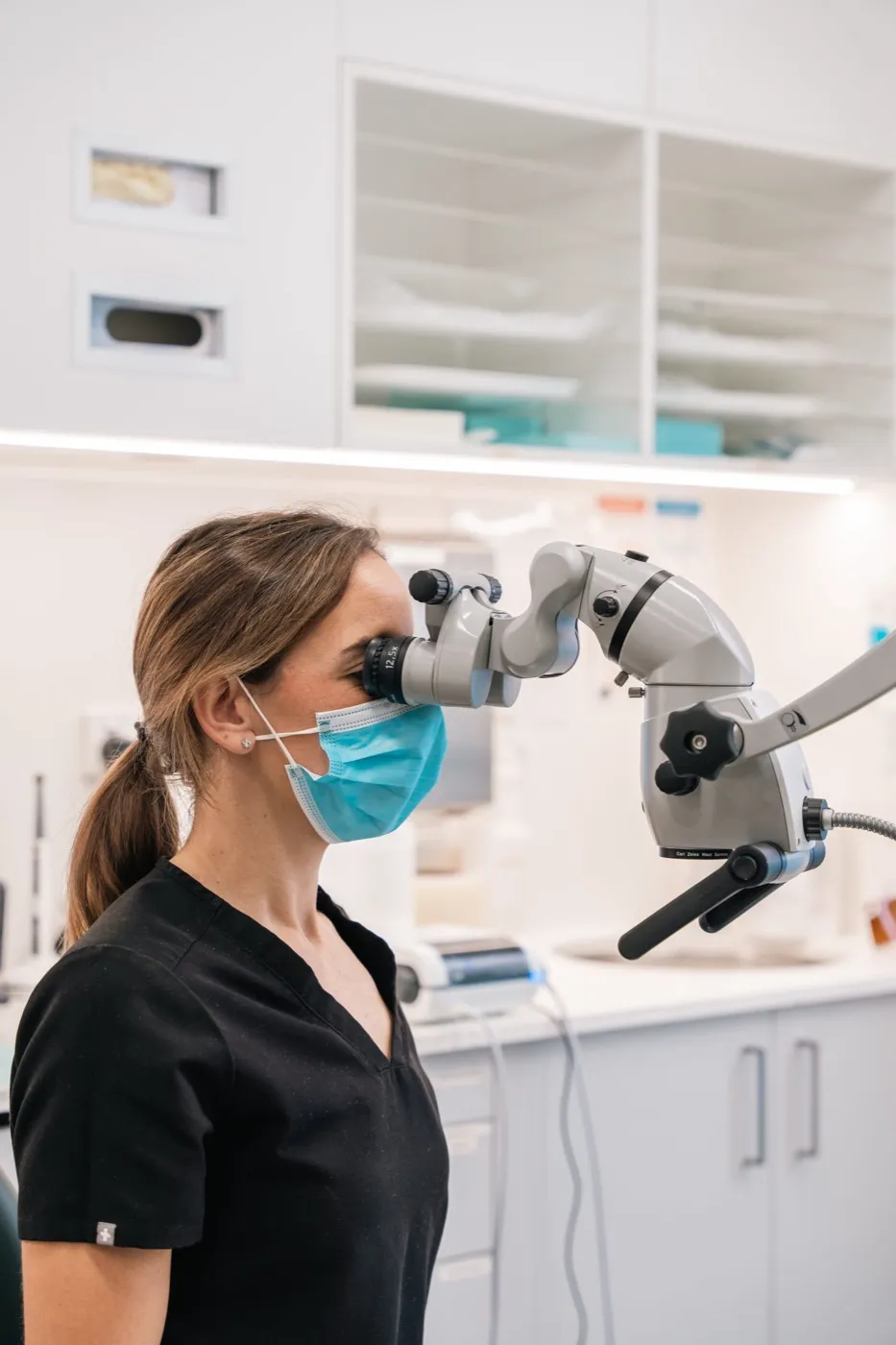 A dentist using a dental microscope