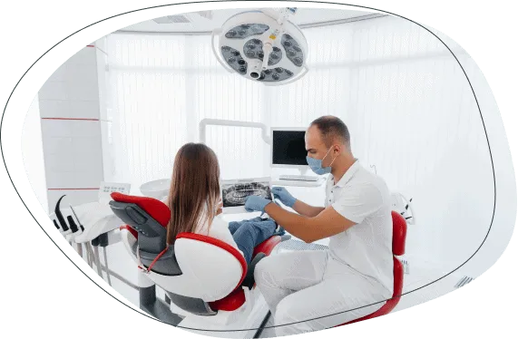 A dentist treating a patient in a bright treatment room